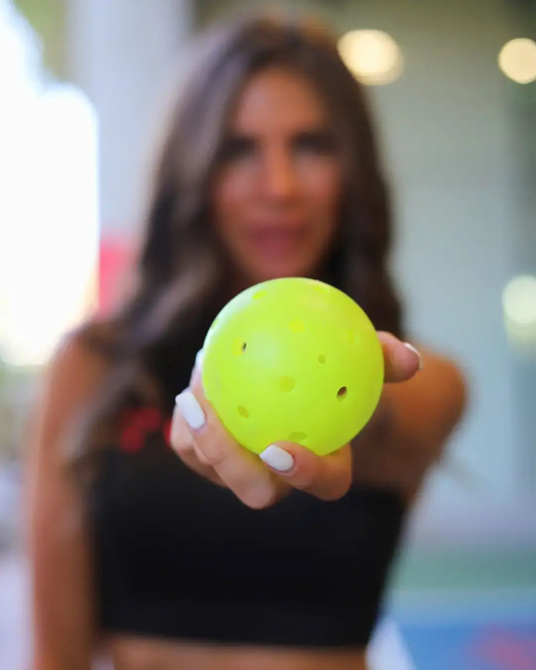 Athlete holding pickleball