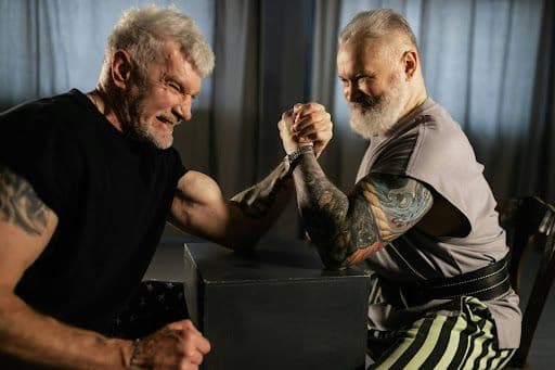 Two ripped men having an arm wrestle