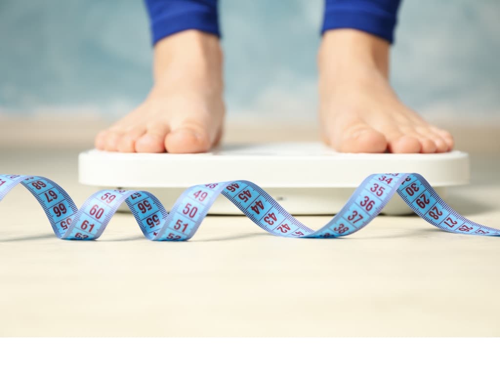 standing on the scale checking weight